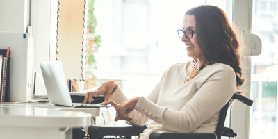 woman in wheelchair typing